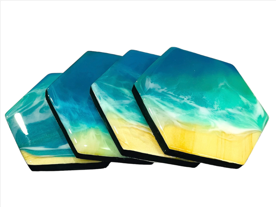 Set of hexagonal ocean wave resin coasters with blue, green, and sandy beach design, handmade coastal home decor
